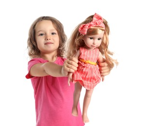 Photo of Cute little girl holding doll on white background