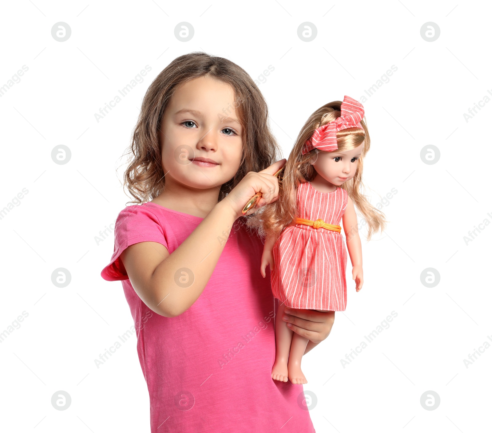 Photo of Cute little girl brushing doll's hair on white background