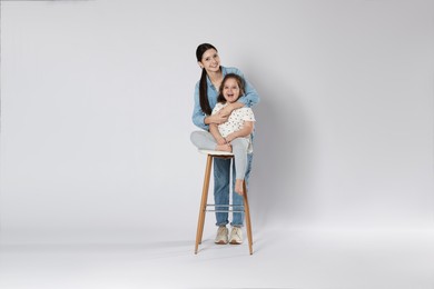 Photo of Portrait of cute sisters on white background