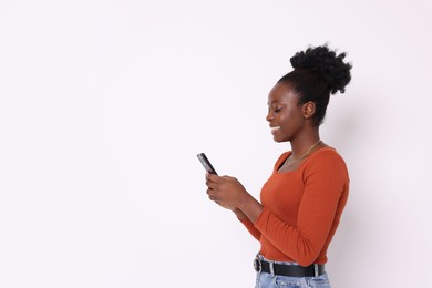 Photo of Happy woman with smartphone on white background. Space for text