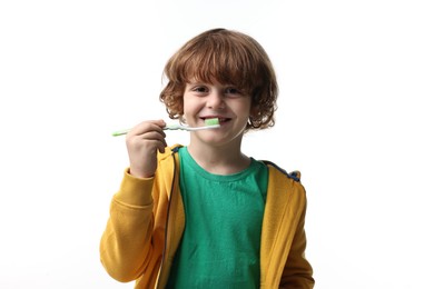 Photo of Cute boy brushing his teeth on white background