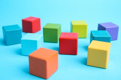 Photo of Many colorful cubes on light blue background