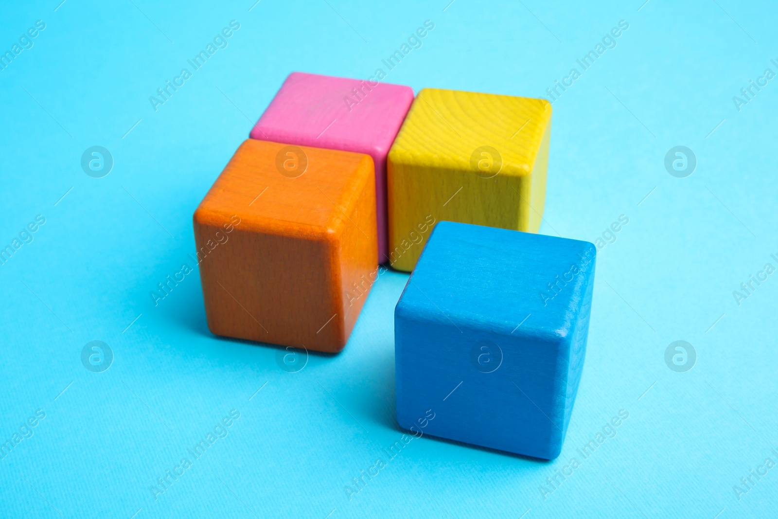 Photo of Many colorful cubes on light blue background