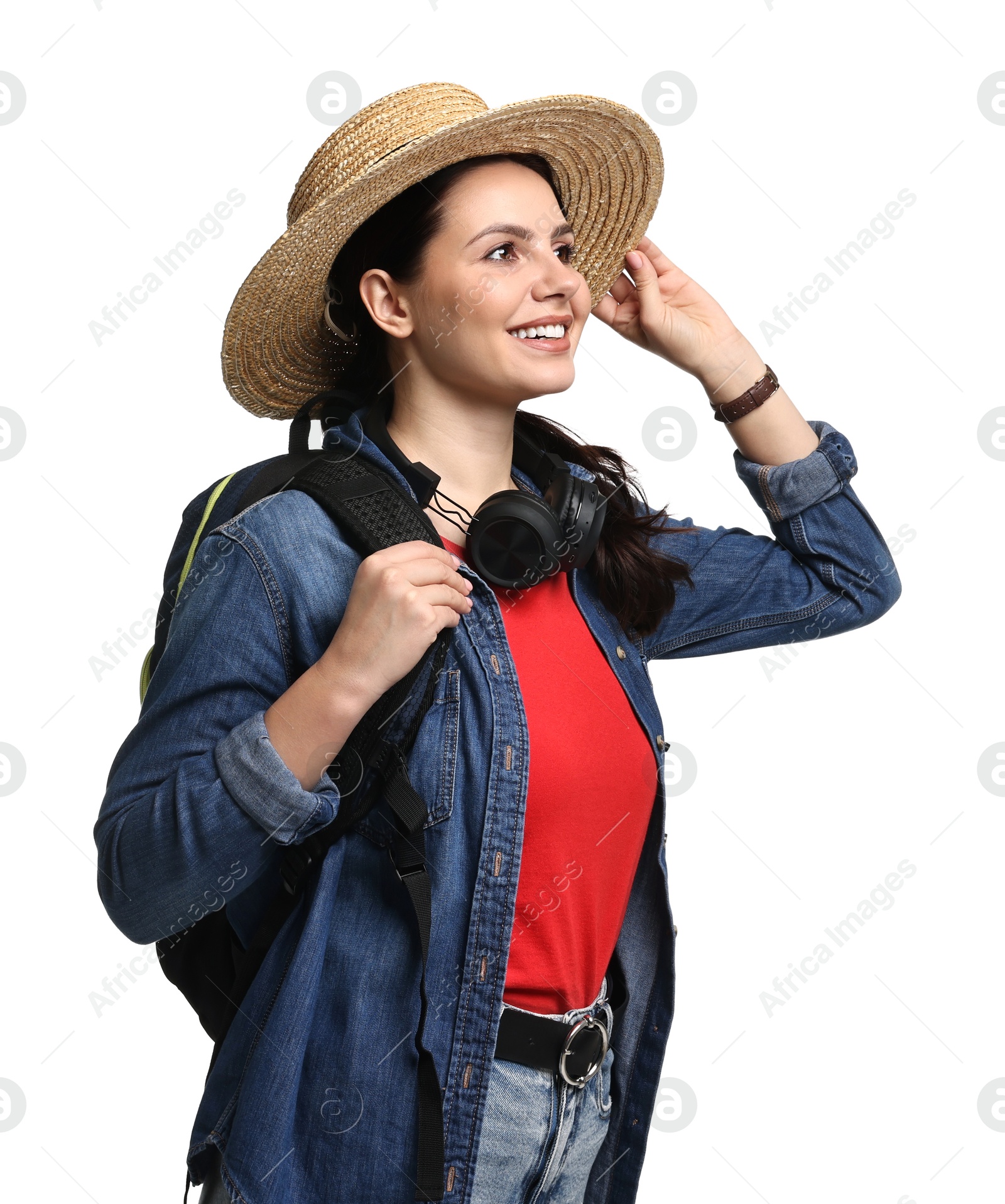 Photo of Young tourist in hat with backpack and headphones on white background