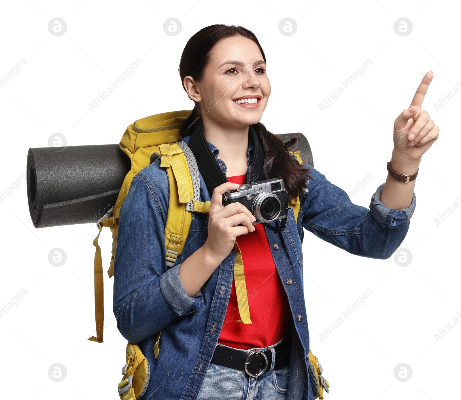 Photo of Young tourist with camera and backpack pointing on white background