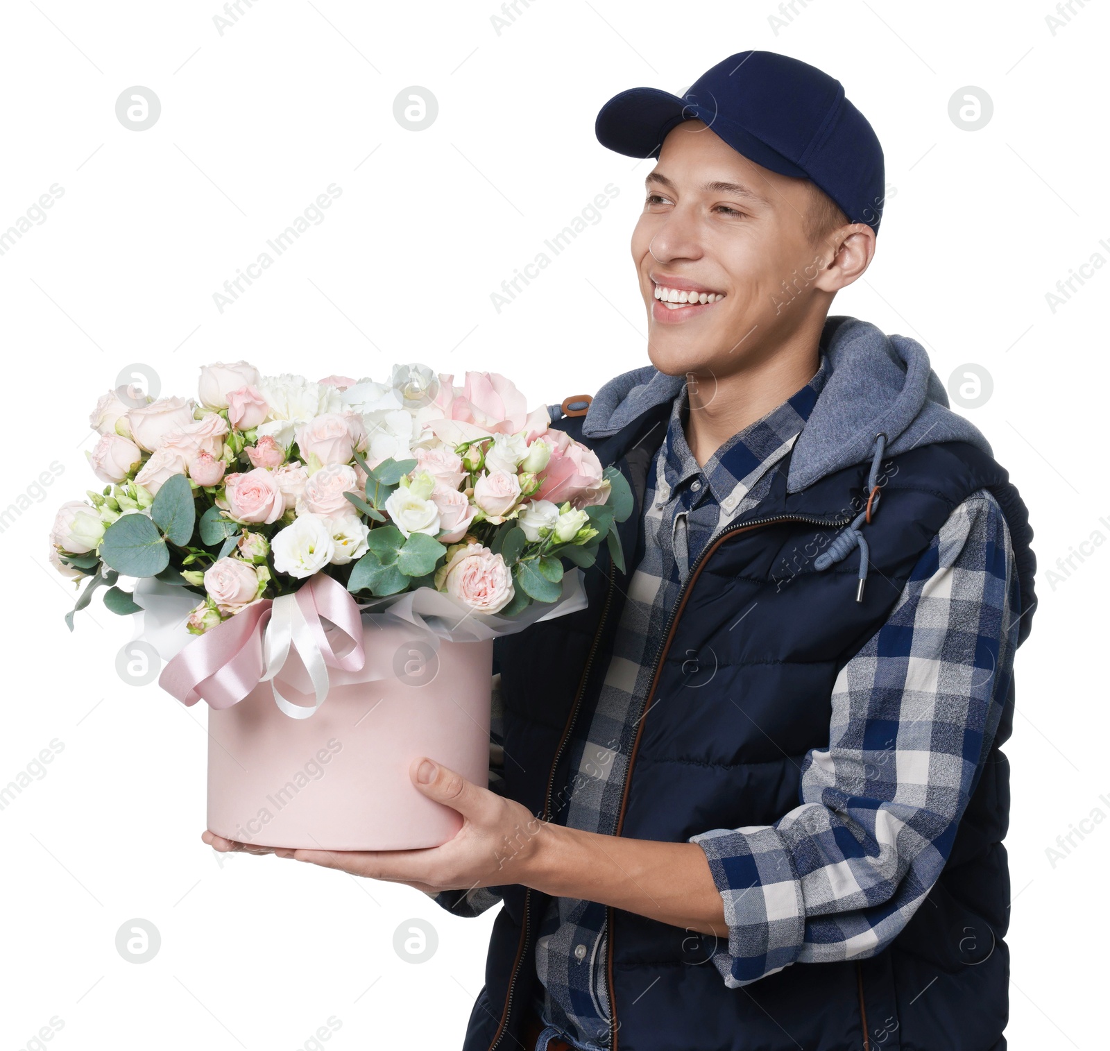 Photo of Smiling delivery man holding gift box with beautiful floral composition on white background