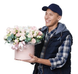 Photo of Smiling delivery man holding gift box with beautiful floral composition on white background