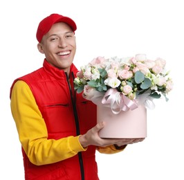 Photo of Smiling delivery man holding gift box with beautiful floral composition on white background