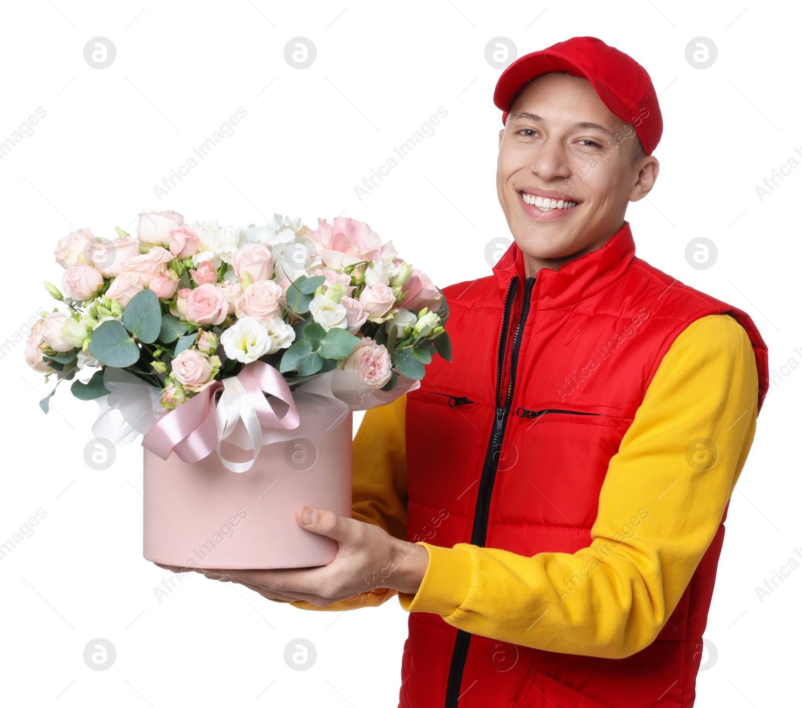 Photo of Smiling delivery man holding gift box with beautiful floral composition on white background