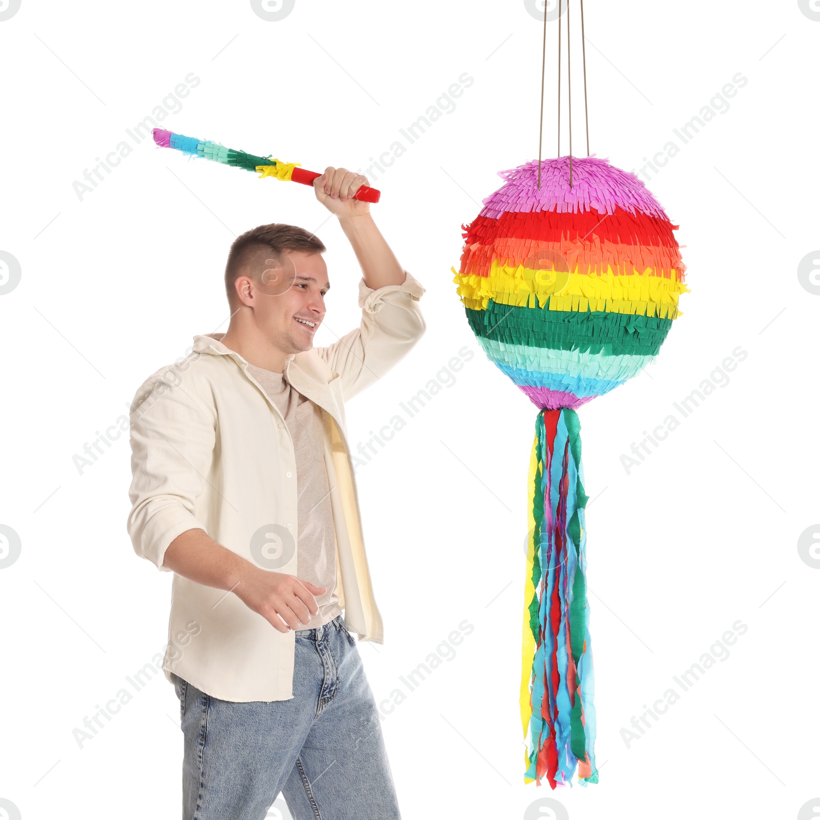 Photo of Happy man breaking pinata on white background