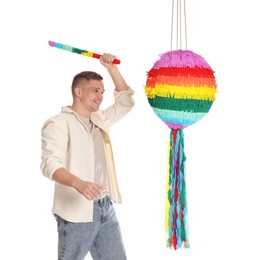 Photo of Happy man breaking pinata on white background