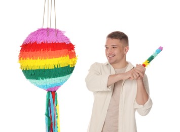 Photo of Happy man breaking pinata on white background