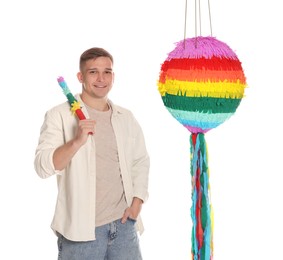 Photo of Happy man with colorful pinata and stick on white background