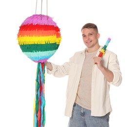 Photo of Happy man with colorful pinata and stick on white background