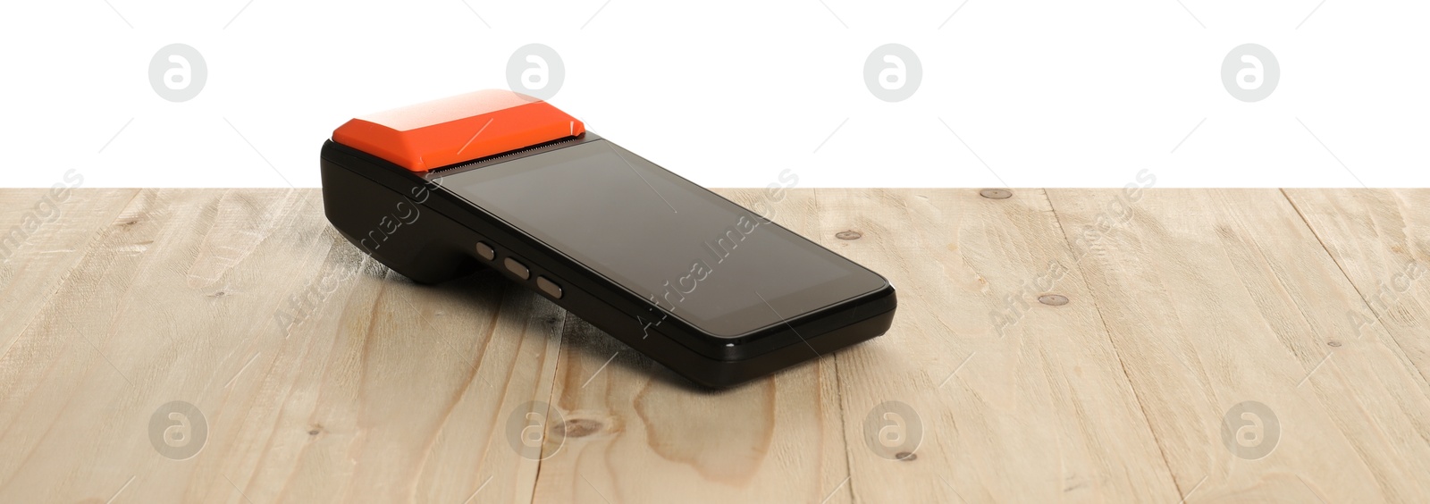 Photo of Payment terminal on wooden table against white background