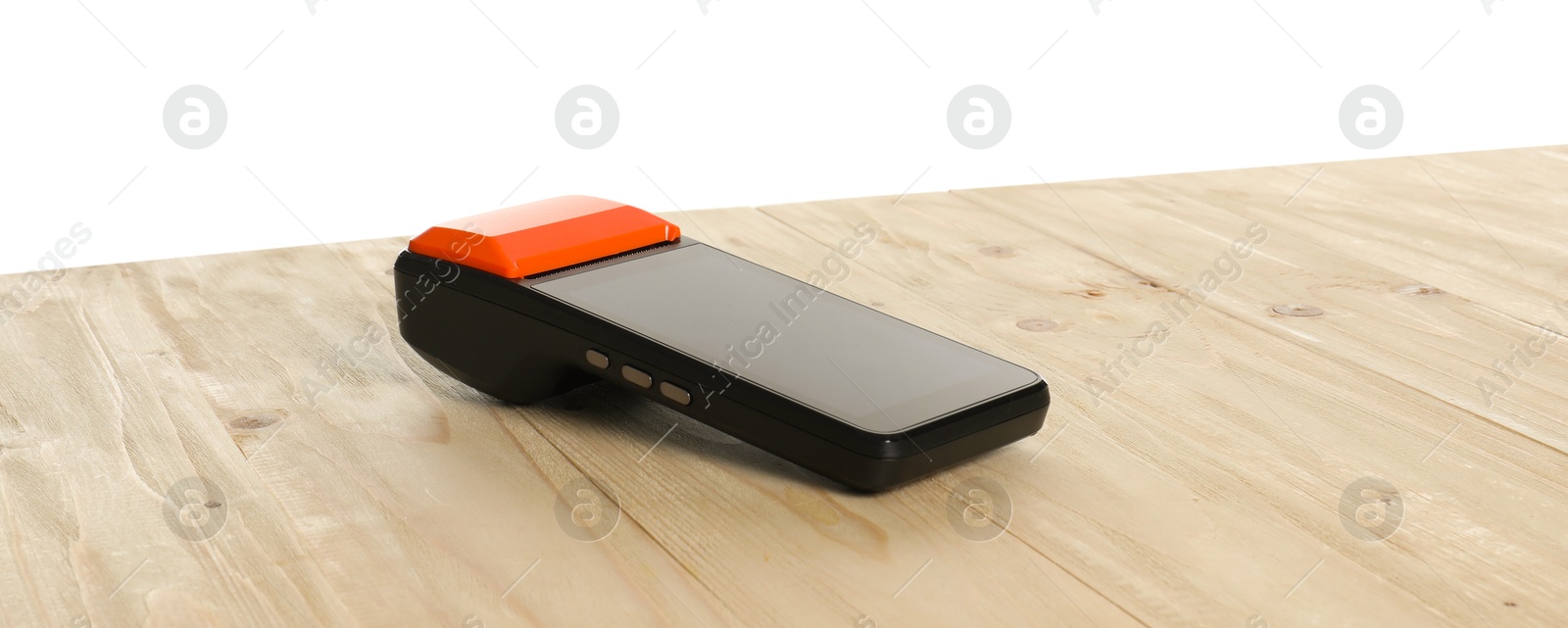 Photo of Payment terminal on wooden table against white background