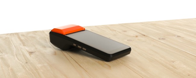 Photo of Payment terminal on wooden table against white background