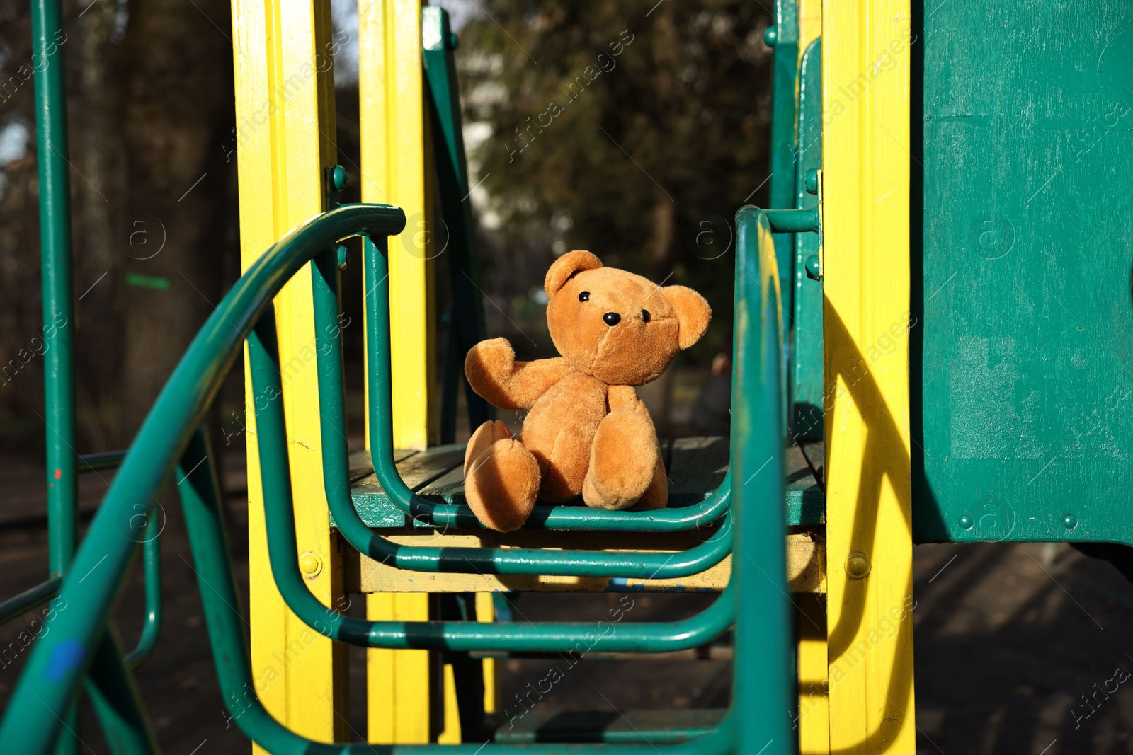 Photo of Lost brown teddy bear on playground outdoors