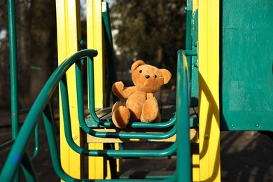 Photo of Lost brown teddy bear on playground outdoors