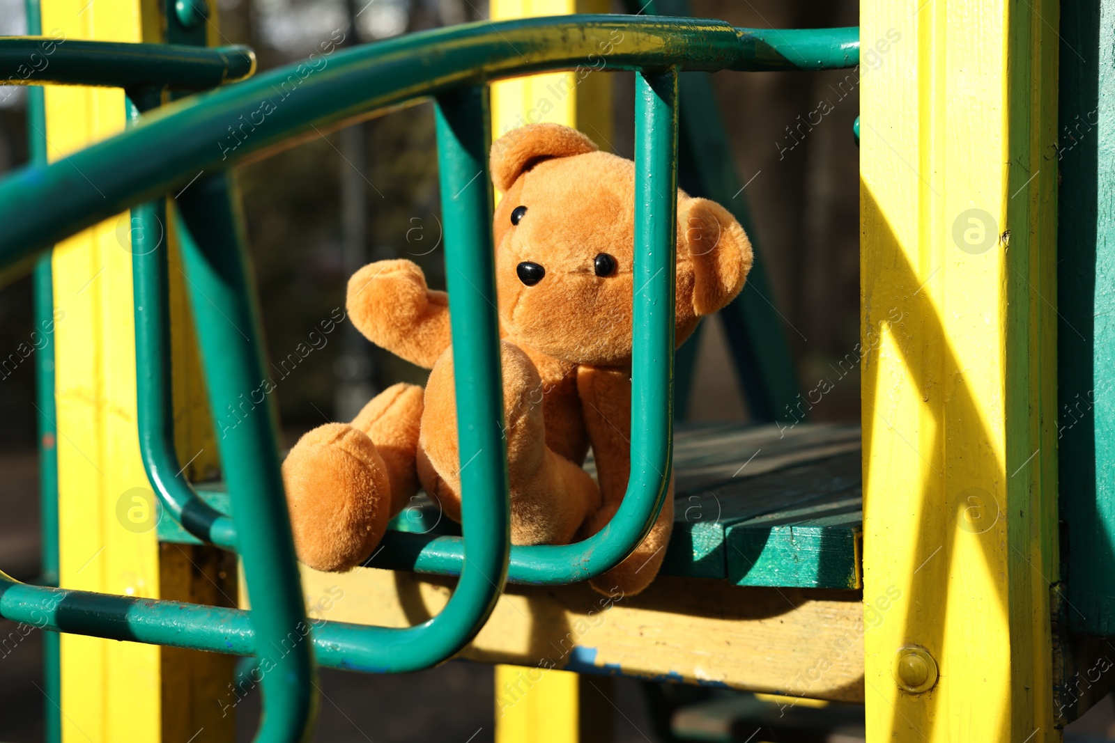 Photo of Lost brown teddy bear on playground outdoors