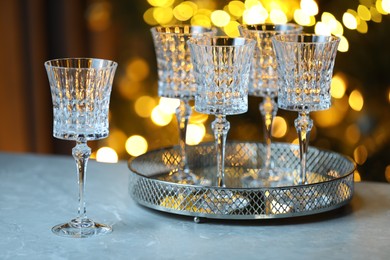 Photo of Wine in glasses on table against blurred lights. Bokeh effect