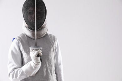 Photo of Fencer with epee on white background, space for text