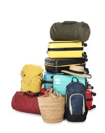 Photo of Stack of colorful suitcases, backpack, beach bag and straw hat isolated on white