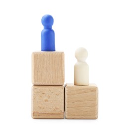 Photo of Human figures on wooden blocks, blue one on top against white background. Competition concept