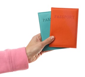 Photo of Woman holding passports in bright covers on white background, closeup