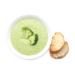 Photo of Delicious broccoli cream soup in bowl and croutons isolated on white, top view