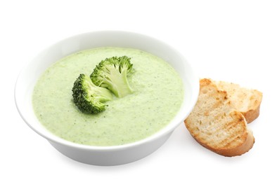 Delicious broccoli cream soup in bowl and croutons isolated on white