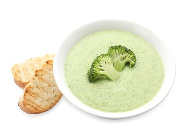 Photo of Delicious broccoli cream soup in bowl and croutons isolated on white