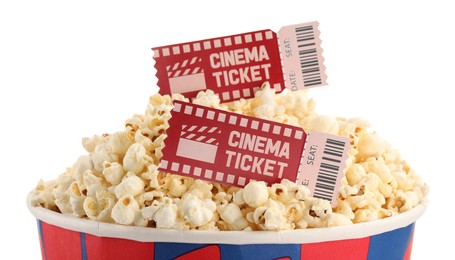 Photo of Tasty popcorn and movie tickets isolated on white