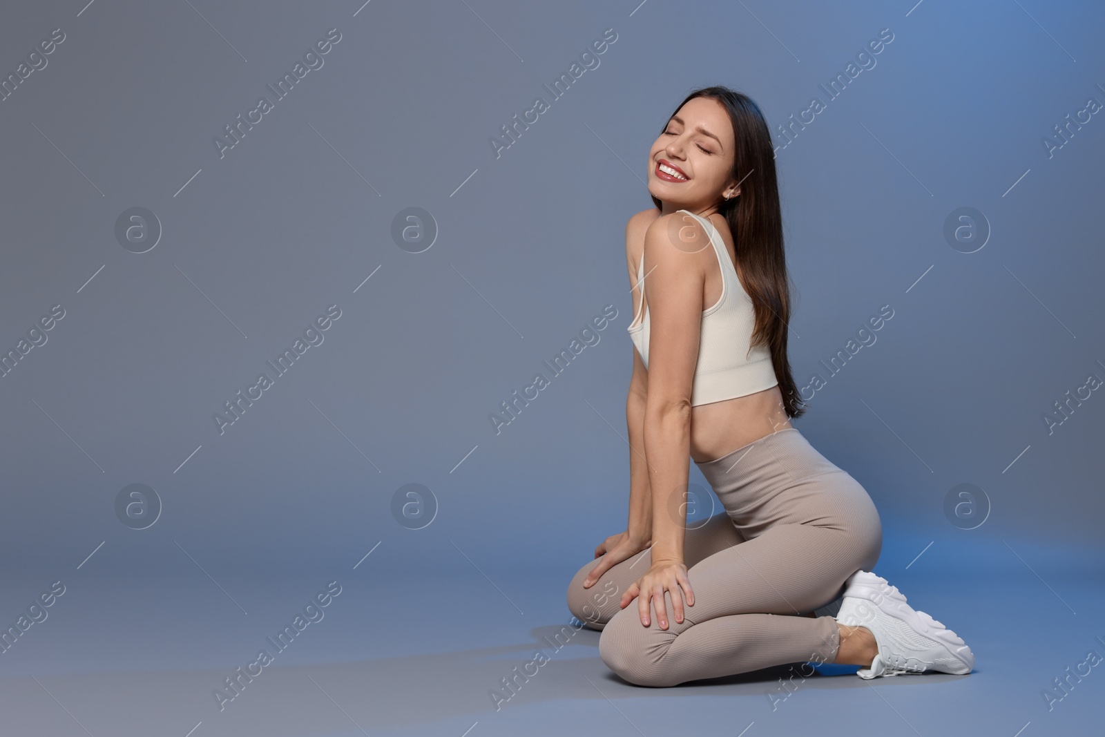 Photo of Beautiful woman in stylish sportswear on grey background. Space for text