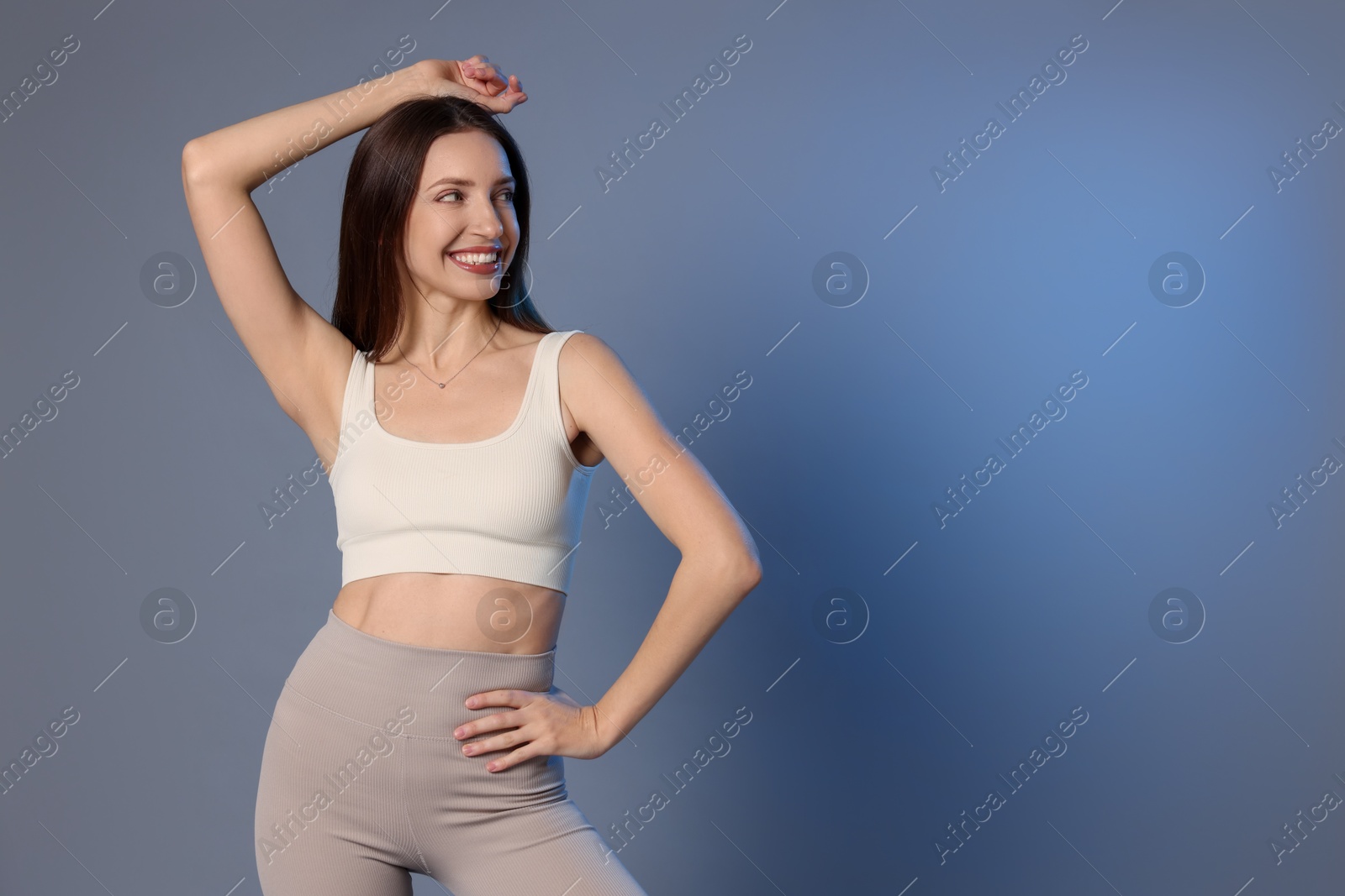 Photo of Beautiful woman in stylish sportswear on grey background. Space for text