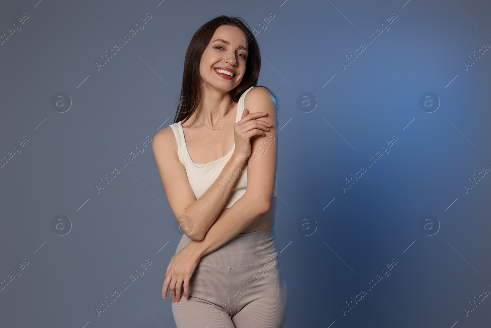 Photo of Beautiful woman in stylish sportswear on grey background