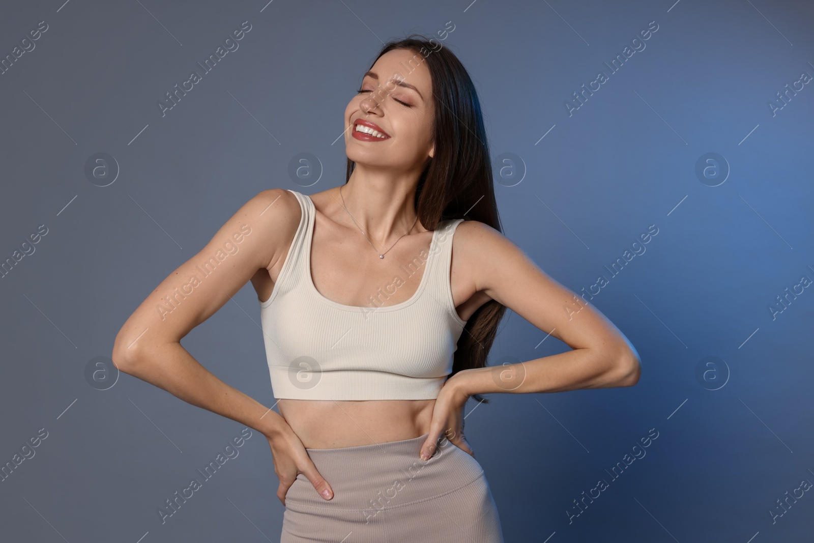 Photo of Beautiful woman in stylish sportswear on grey background