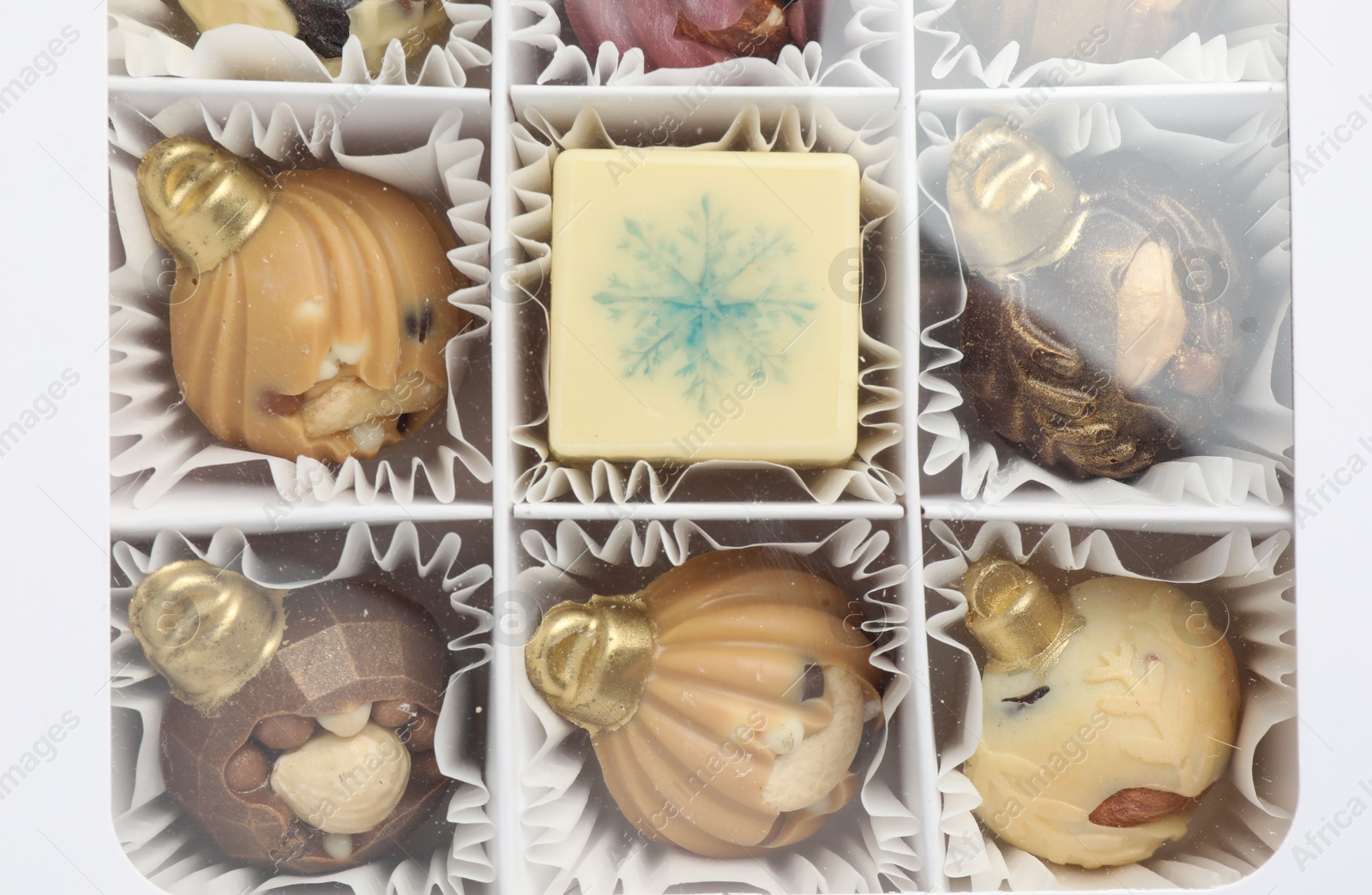 Photo of Box with delicious chocolate in shape of Christmas ornaments, top view