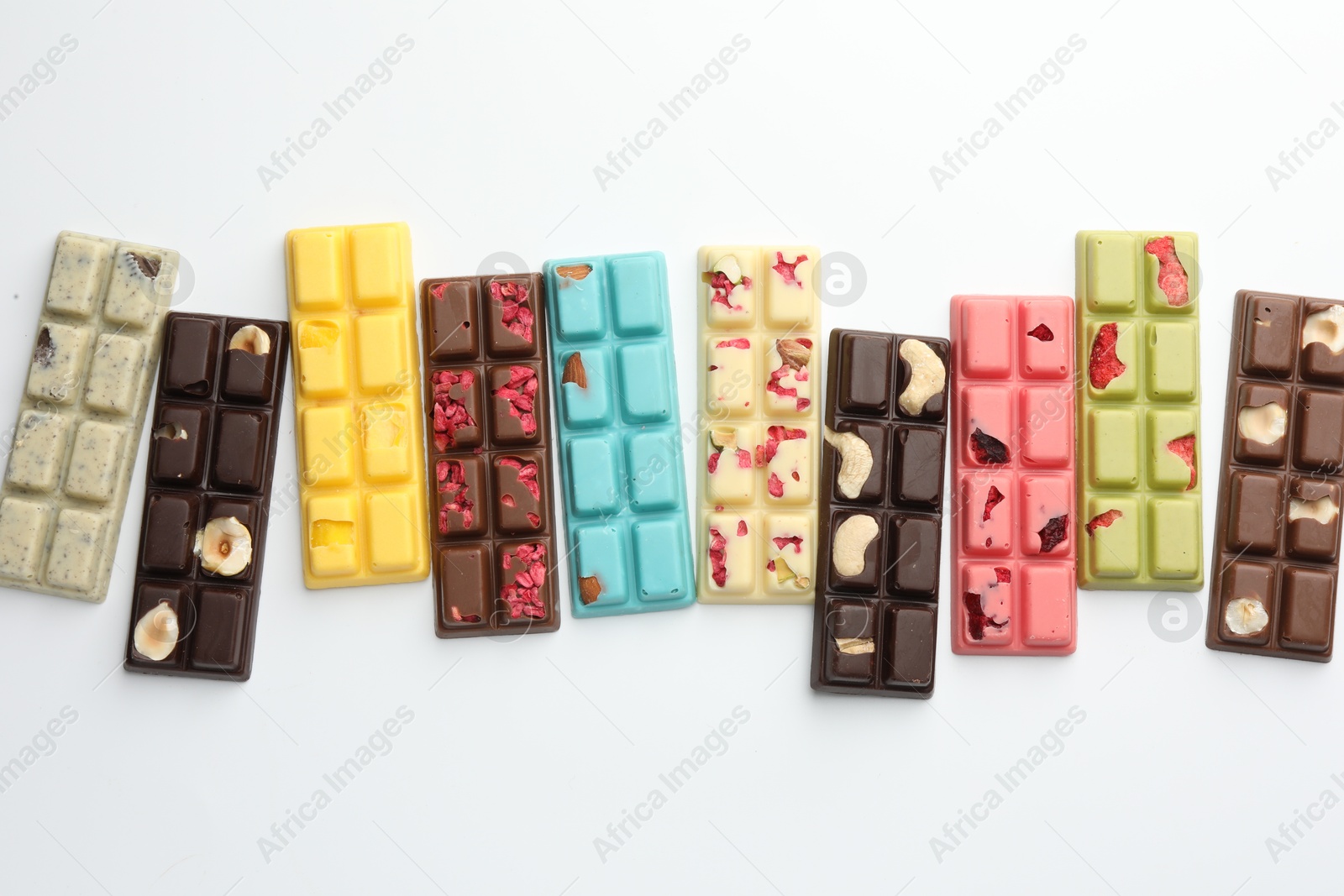 Photo of Different tasty chocolate bars on white background, flat lay