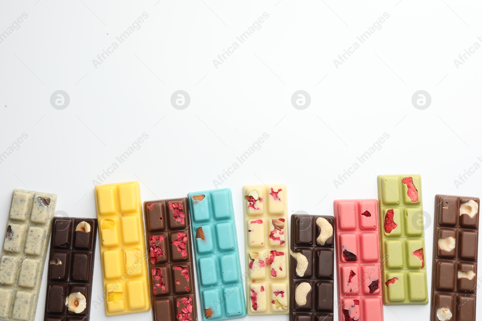 Photo of Different tasty chocolate bars on white background, flat lay. Space for text