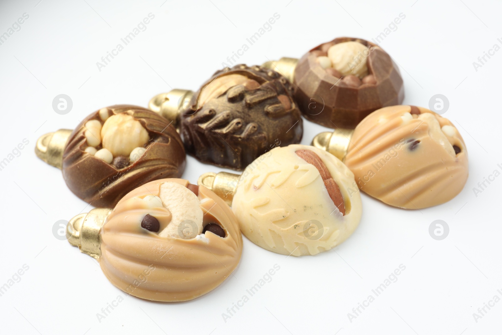 Photo of Delicious chocolate in shape of Christmas baubles on white background, closeup