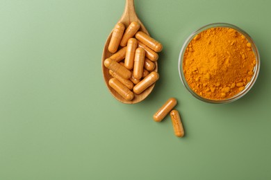 Photo of Many turmeric capsules and powder on light green background, flat lay. Space for text