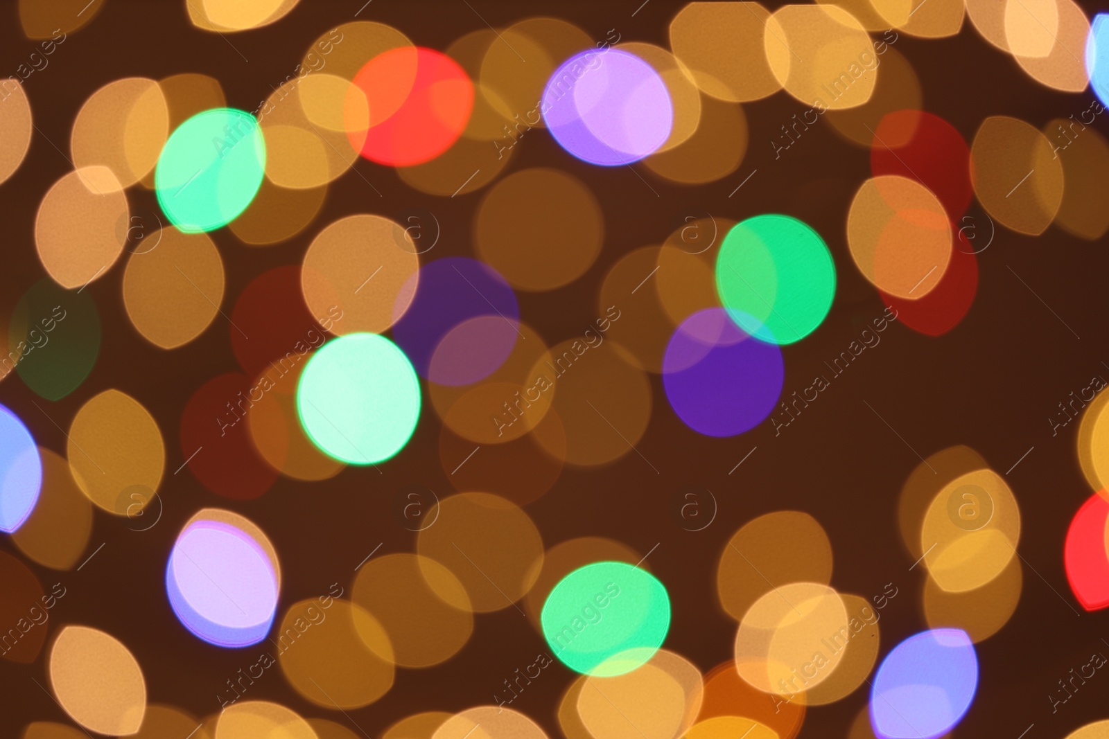 Photo of Blurred view of colorful lights on color background, bokeh effect