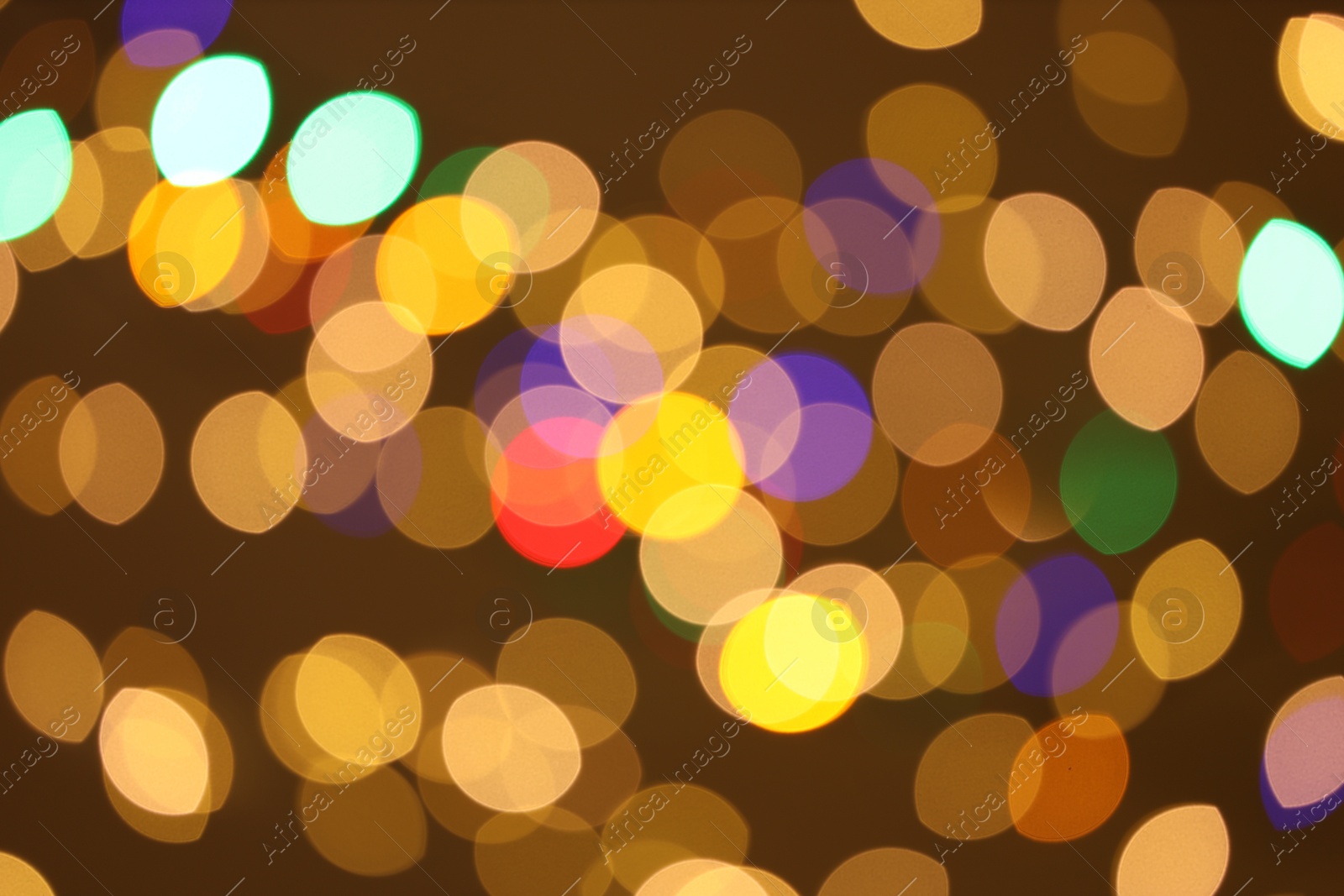 Photo of Blurred view of colorful lights on color background, bokeh effect