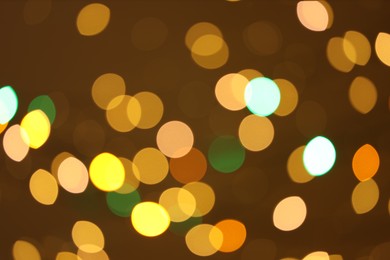 Photo of Blurred view of colorful lights on color background, bokeh effect