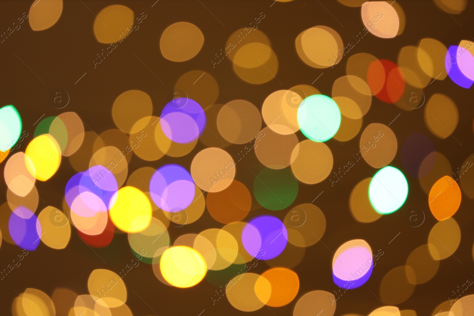 Photo of Blurred view of colorful lights on color background, bokeh effect