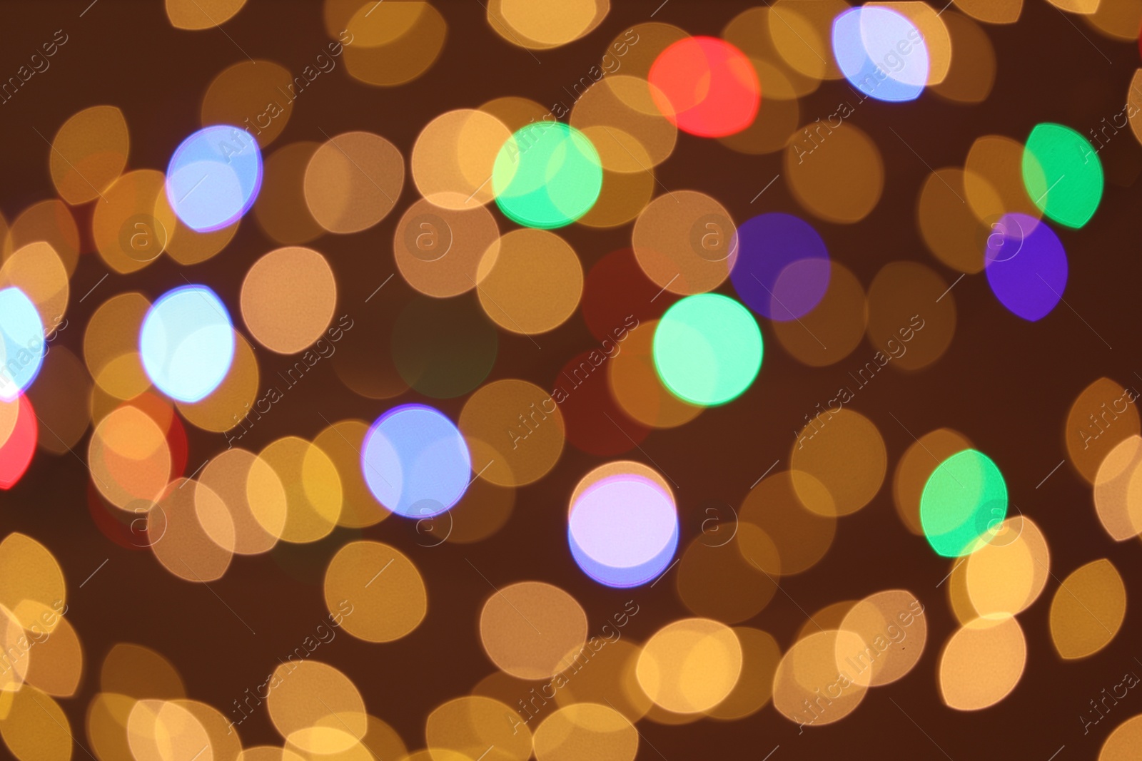 Photo of Blurred view of colorful lights on color background, bokeh effect