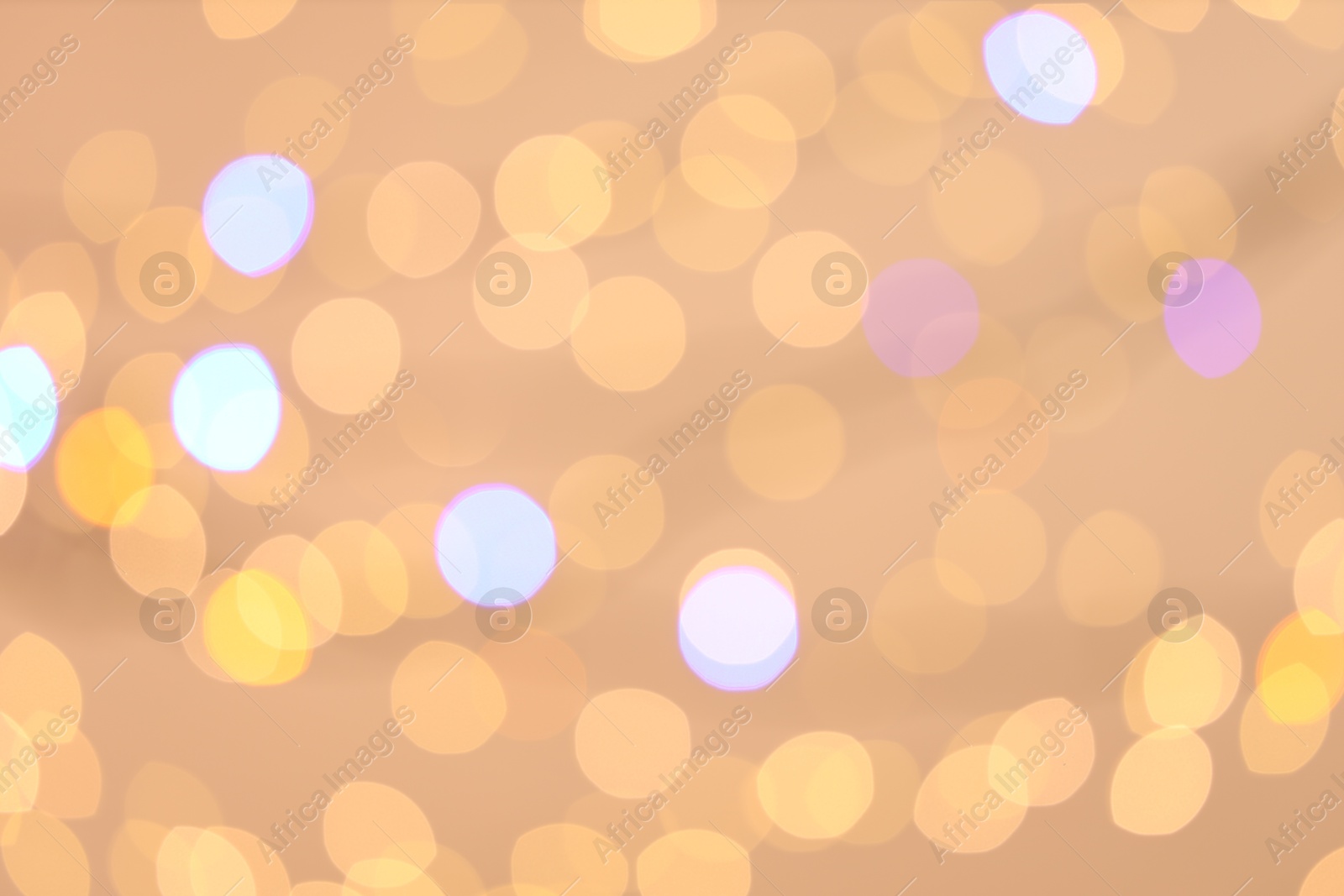 Photo of Blurred view of colorful lights on light background, bokeh effect