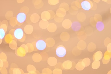 Photo of Blurred view of colorful lights on light background, bokeh effect