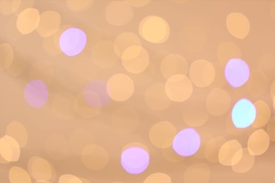 Photo of Blurred view of colorful lights on light background, bokeh effect